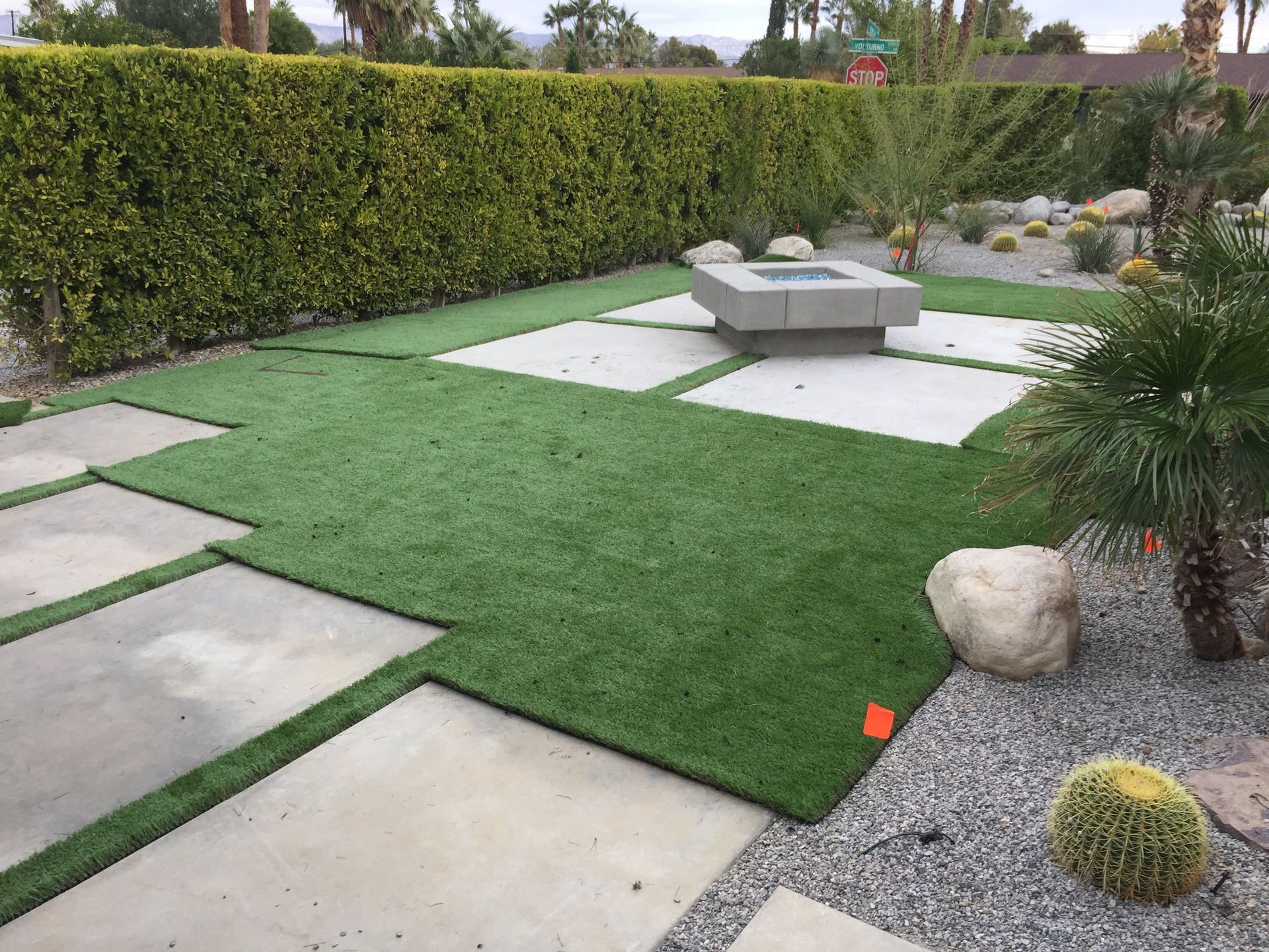 Backyard putting green with a flagstick and desert mountains beyond